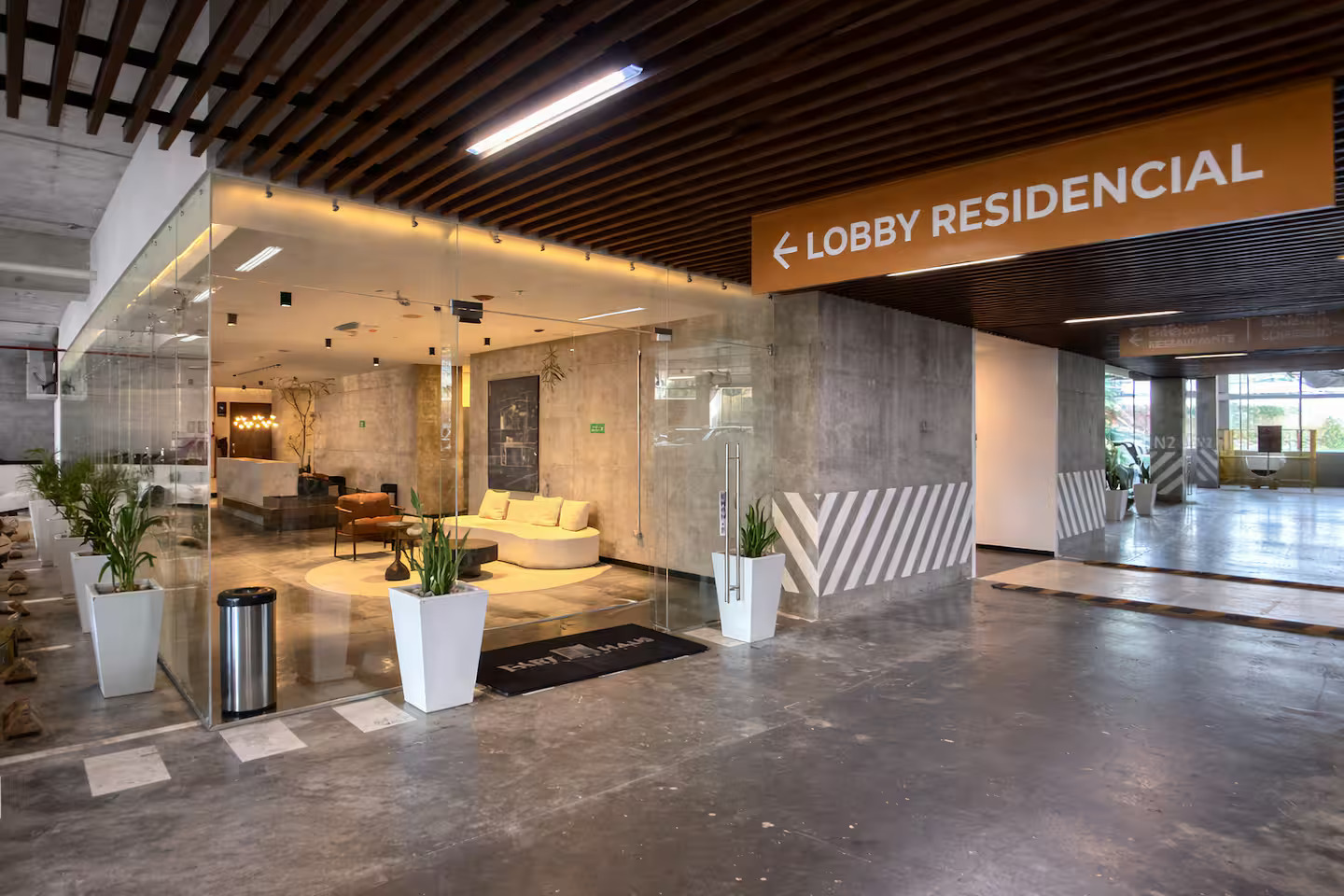 Lobby entrance with glass walls and modern seating at Art Haus Tower
