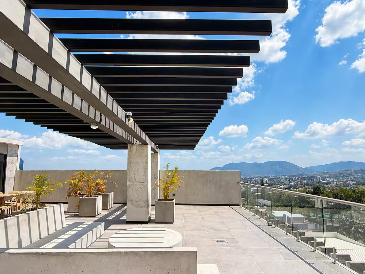 Rooftop terrace with dining table, chairs, and city views at Art Haus Tower